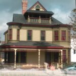 Restored Victorian historic house showcasing preserved architectural details, original woodwork, wraparound porch, and historic craftsmanship by Artisan Historic Contracting.