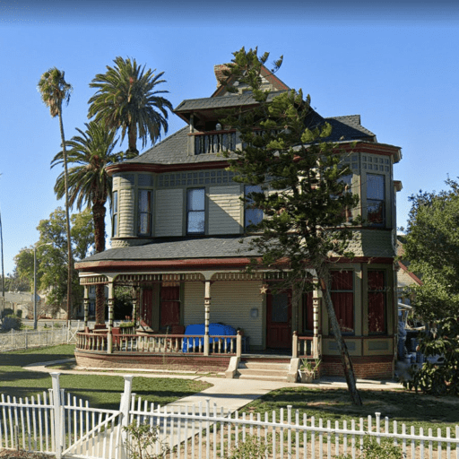 Restored Victorian historic house showcasing preserved architectural details, original woodwork, wraparound porch, and historic craftsmanship by Artisan Historic Contracting.